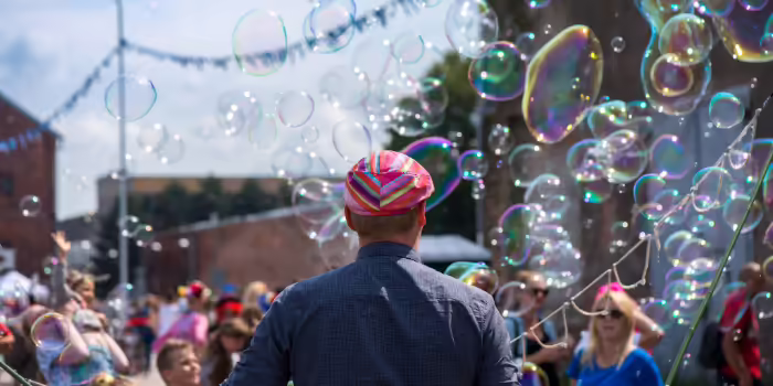person making bubbles at a crowded downtown festival
