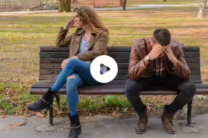 sister and brother sitting on bench disagreeing