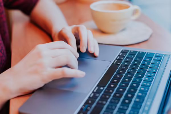 hands typing on laptop keyboard