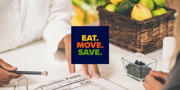A basket full of fruits and vegetables. Someone holding a pencil with a clipboard on a table. The eat.move.save.logo is in the middle. 