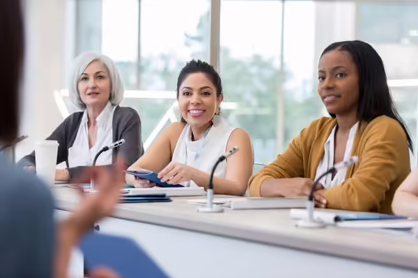 three women sitting on a council