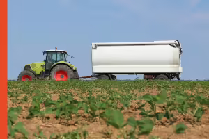Manure spreader in a soybean field