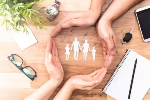 hands around paper cutout family