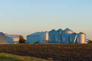 Grain bins and shed in the sunset