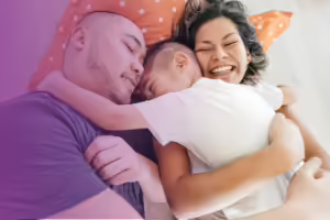 an asian dad, mom and son hugging