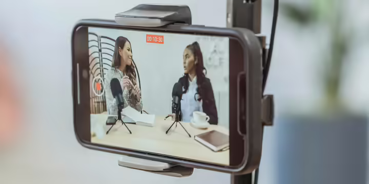 two people recording podcast on mobile device