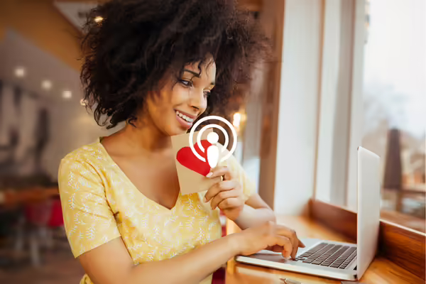 woman with heart card sitting at computer