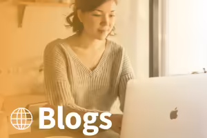 asian woman sitting a a table working on a laptop. text blogs