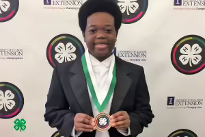 boy holding a 4-H medallion