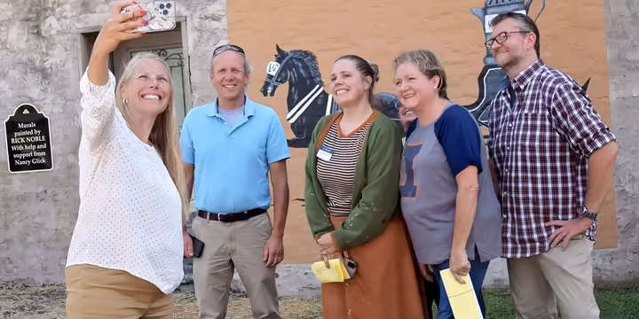 a group of adults taking a selfie