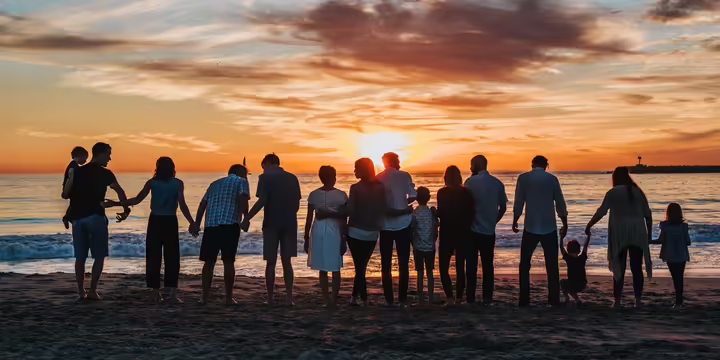 siholette of family on the beach