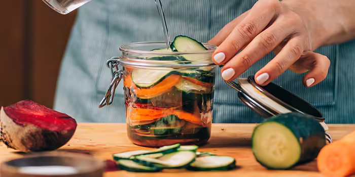 sliced vegetables with brine prepped for fermenting