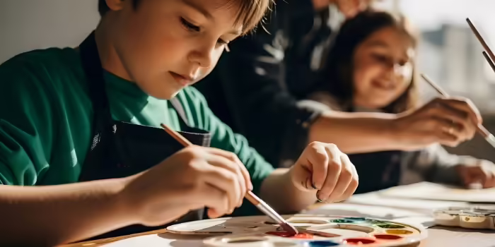 A young boy and girl painting
