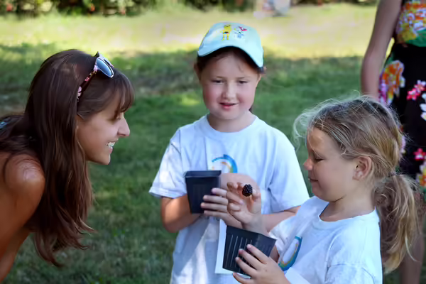 kids enjoying berries from Bloom Community School's Food Forest