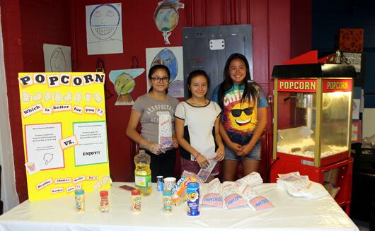 children with popcorn stand at Healthy Carnival