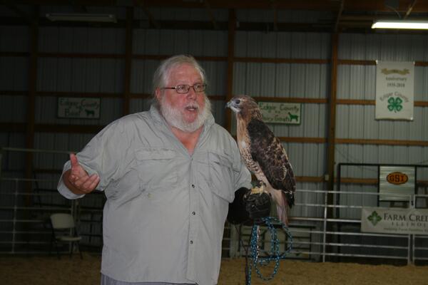 man holding red-tailed hawk