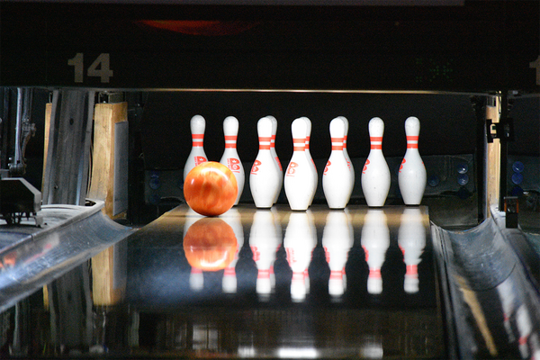 bowling pins set-up with ball rolling down lane