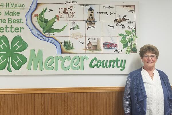 joyce smith poses with a mercer county sign