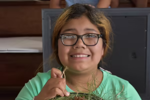 Girl with glasses and green shirt