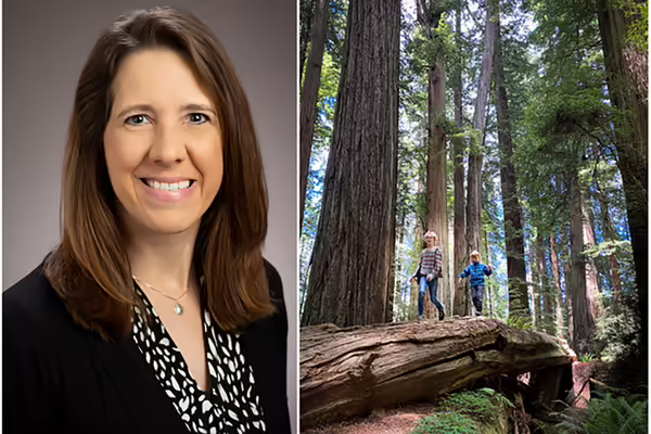 A photo of woman next to children in nature