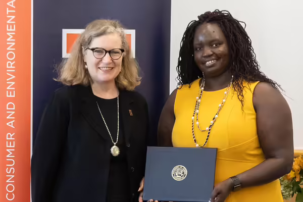 two women holding an award
