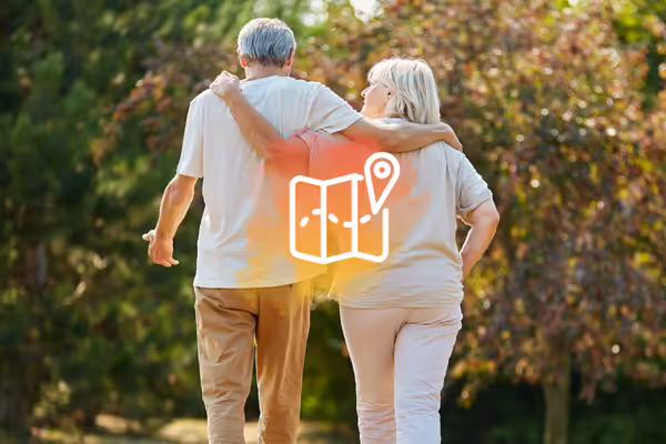 Two senior adults walking together with a map behind them.