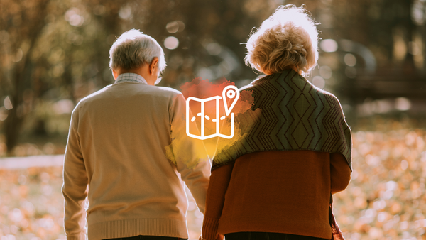 Two older adults walking together.
