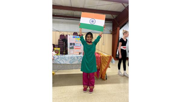 Girl in India dress holding India flag above her head