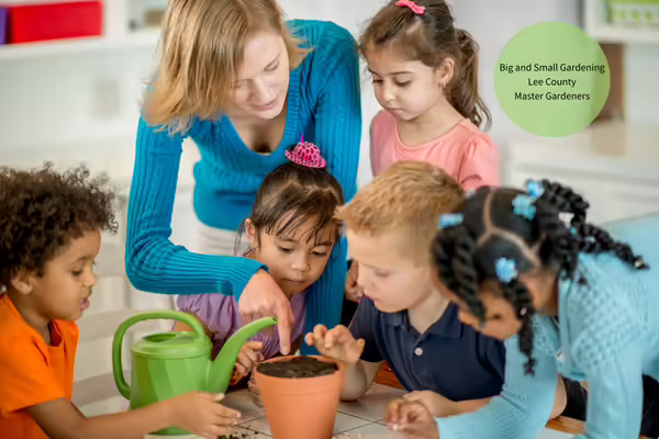 Master Gardener showing kids how to plant a seed