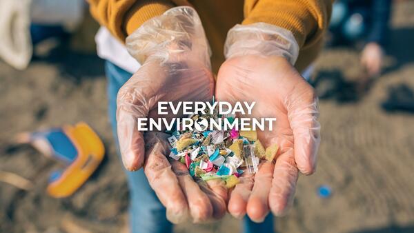 everyday environment hands holding plastic on a beach