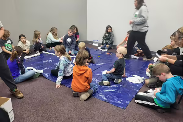 cloverbuds getting ready to tye-dye their t-shirts
