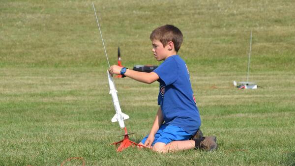 little boy getting ready to launch a rocket