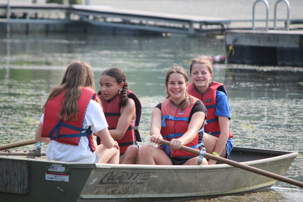 4-H campers enjoy water activities in row boat