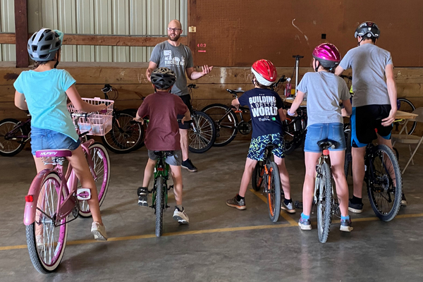  Rich Backeberg, owner of The Bicycle Hub in Pecatonica teaches the kids basic bicycle maintenance and proper helmet fitting during the 2023 Youth Bicycle Rodeo.