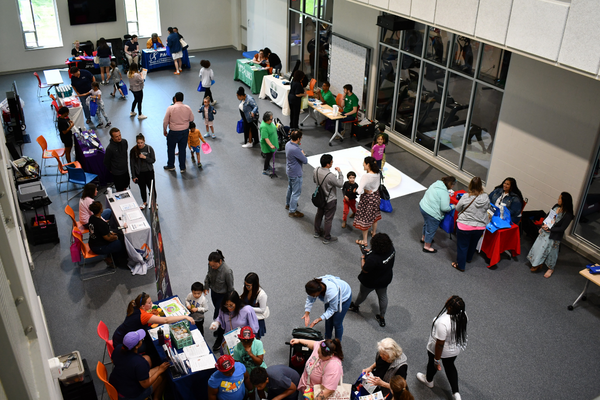 Groups of people looking at booths at a resource fair