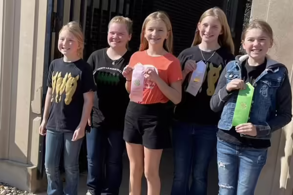 five girls standing with ribbons