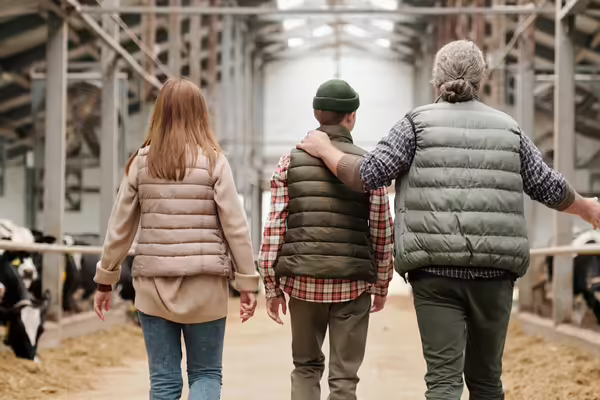 3 people walking in a farm