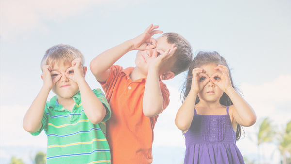 three kids acting silly with their fingers around their eyes
