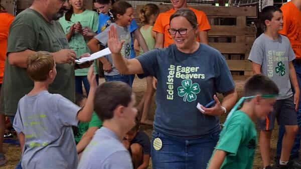 4-H leader high-fiving a member