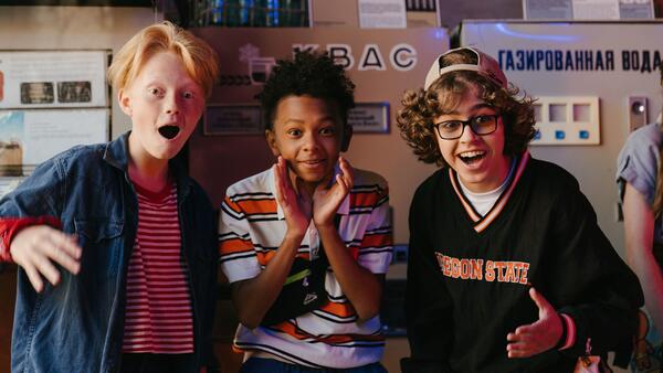 Three boys in a school hallway 