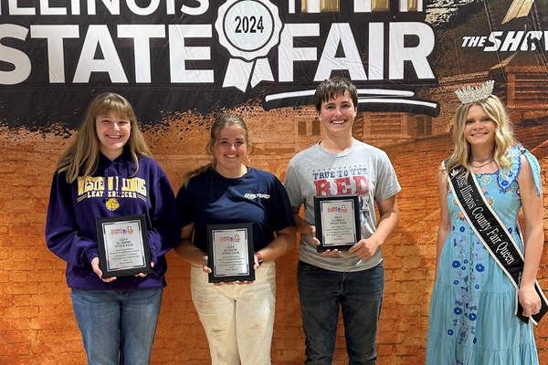 Winners pose with plaques.