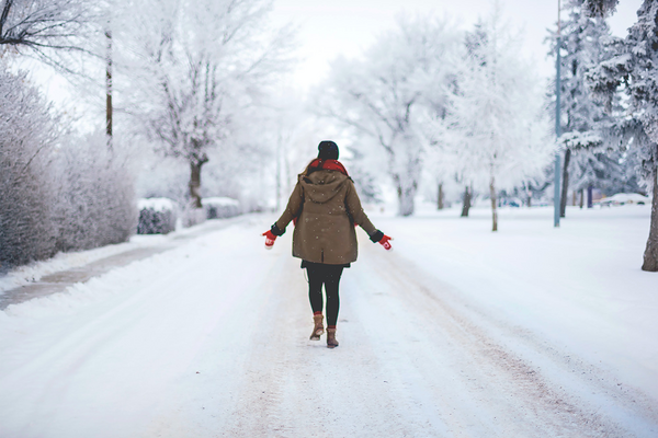 person in brown coat in snow