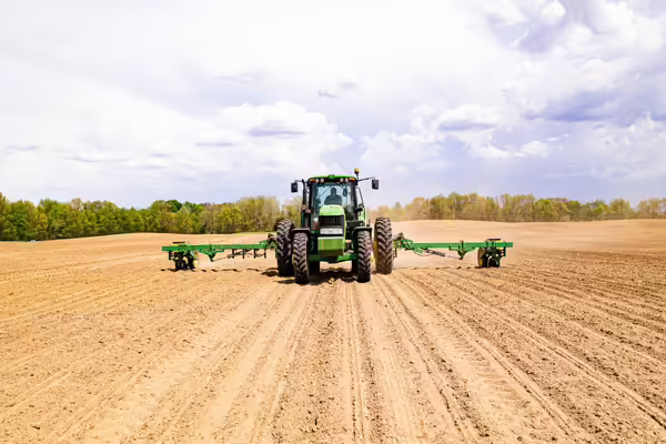 Tractor driving in a dirt field