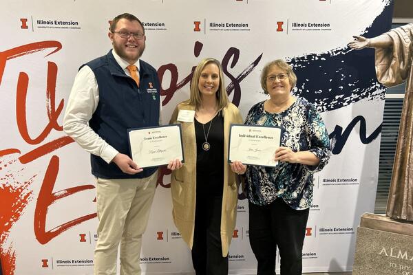 County Director, Tara Buerster, with Ryan Littlejohn and Jane Jones holding awards