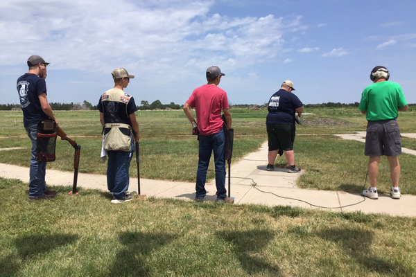 A volunteer and youth on the range.