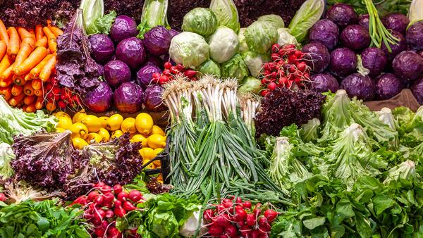 A variety of vegetables displayed at a grocery store. 