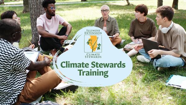 A group of people outside on grass having a discussion 