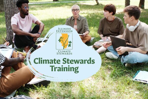 a group of people having a discussion outside sitting in the grass