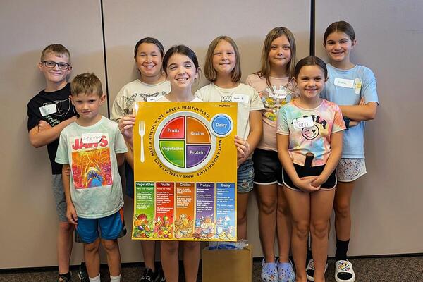 group of children holding MyPlate poster