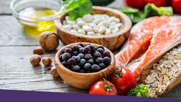 A selection of heart-healthy foods laid out on a wooden table.